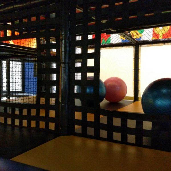 exercise balls, netted walls, playroom gathering area attraction