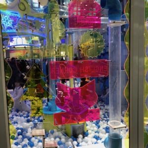 clear maze wall with puzzles and moving balls